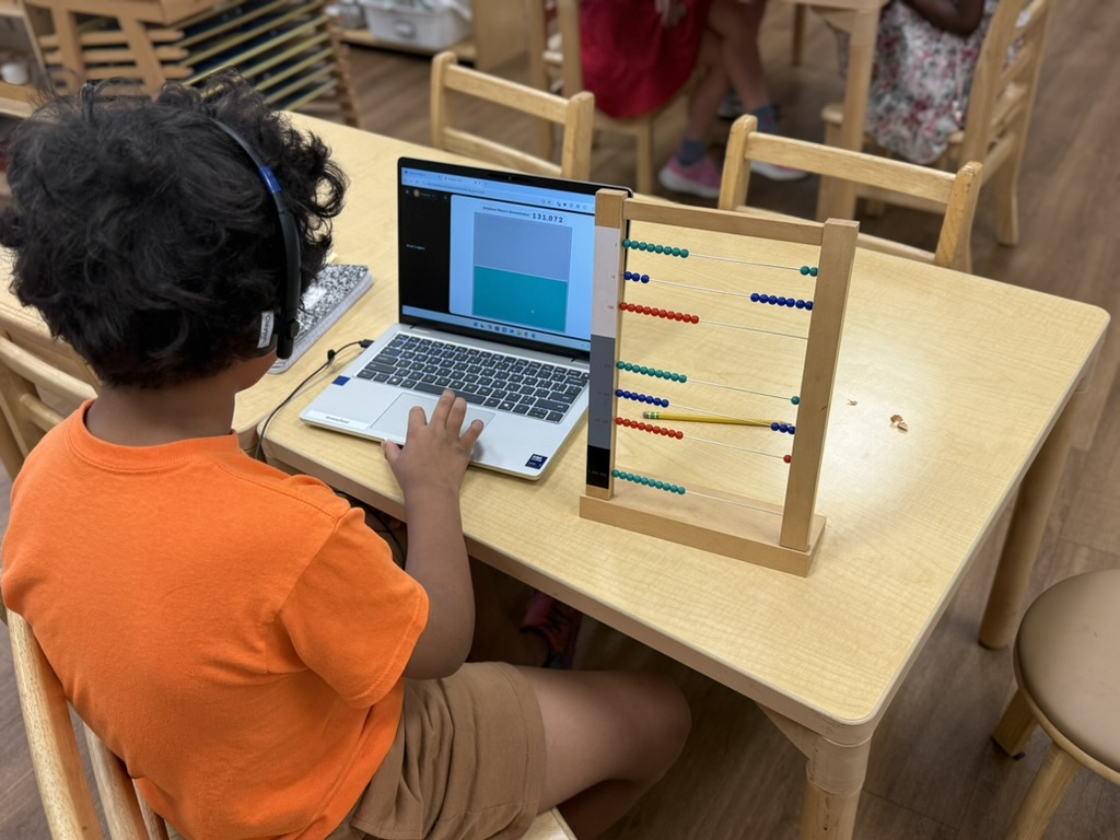 Student working with laptop and abacus side by side in the classroom