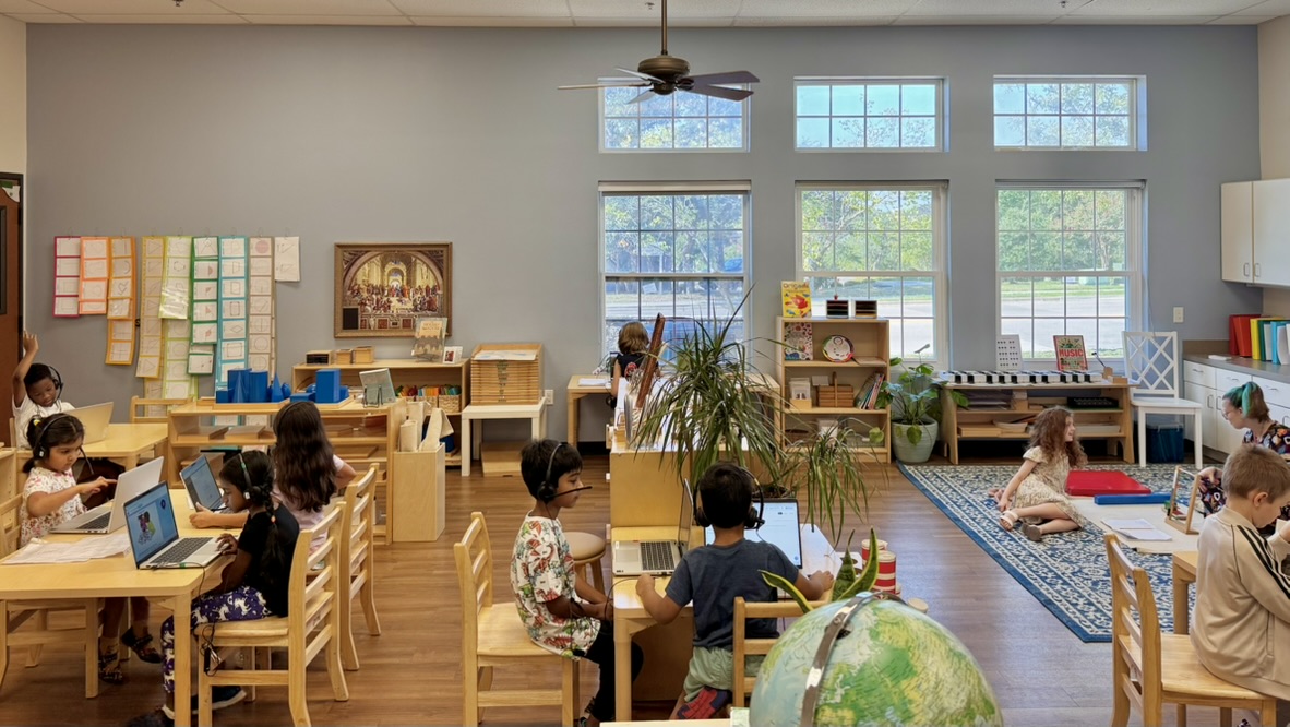 Wide view of the Montessorium classroom with students working independently